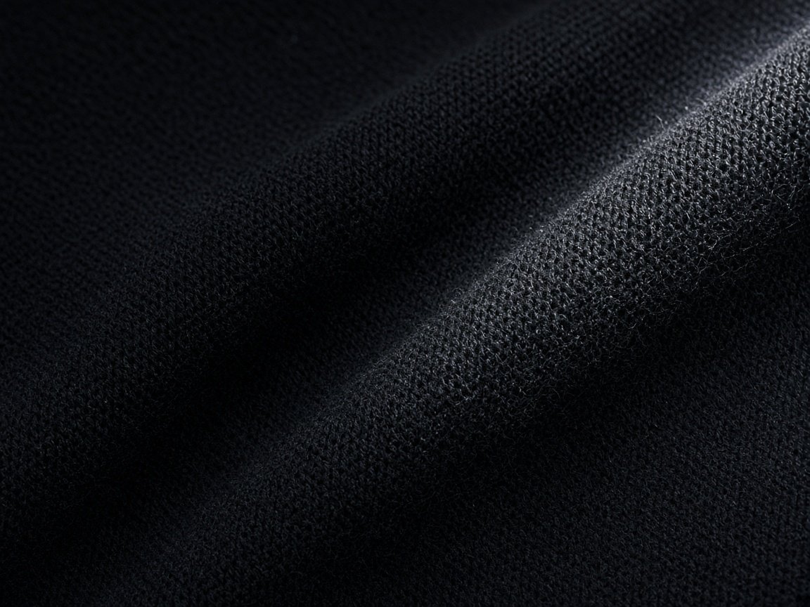 Black merino knit, photographed as a textile study.